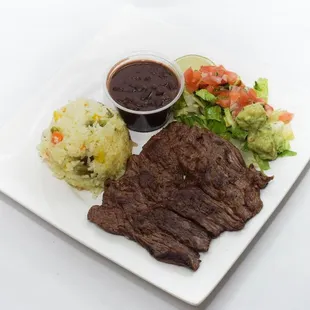 a plate of steak, mashed potatoes, and vegetables