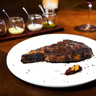 A selection from the Butcher&apos;s Block. Plated with shallot marmalade and sweet garlic chips. Served with a &quot;paddle of sauce&quot;.
