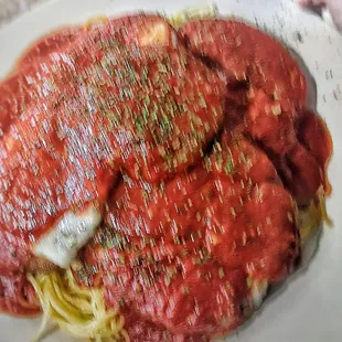 Eggplant Parm platter, comes with garlic bread sticks and a side, finger for scale