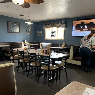 a dining area with tables and chairs