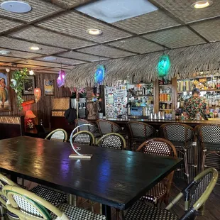 a dining area with tables and chairs