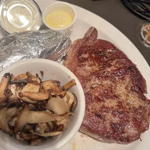 Ny strip steak with baked potatoes and mushroom