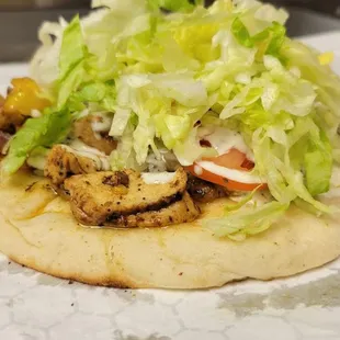 a pizza topped with lettuce and tomatoes