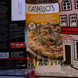 a hand holding a menu