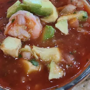 Shrimp cocktail. Fresh shrimp in traditional cocktail sauce made from scratch. Topped with avocados and served with crackers.