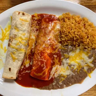 Two item combination plate with shredded beef, burrito and enchilada, Spanish rice, and beans on the side