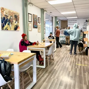 people sitting at tables in a coffee shop