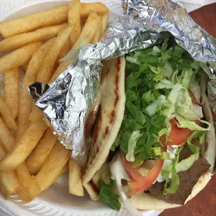 This gyro was incredible! I've never had one this good. I think they cut meat off the cone and then cook it on the flat top.