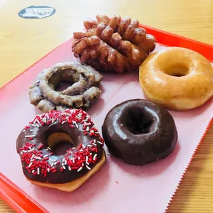 a variety of donuts on a tray