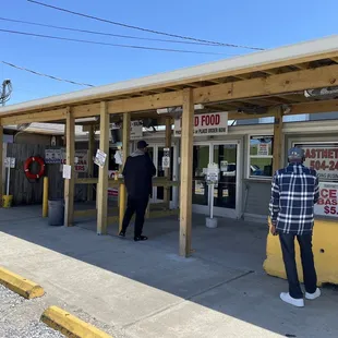 a man standing in front of a restaurant