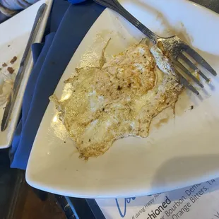 The supposed fried sunny side up egg (not) for the burger that came out as we were getting our check.