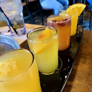 Mimosa and bellini flight! Left to right: passion fruit bellini, peach bellini, raspberry mimosa, classic mimosa