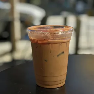 a cup of iced coffee on a table