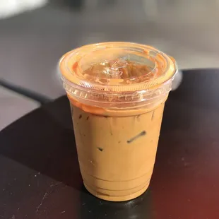 a cup of iced coffee on a table