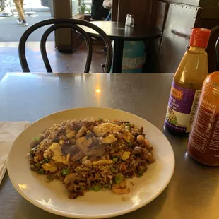 a plate of food and a bottle of sauce