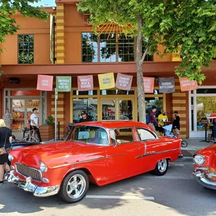 classic cars parked in front of the store