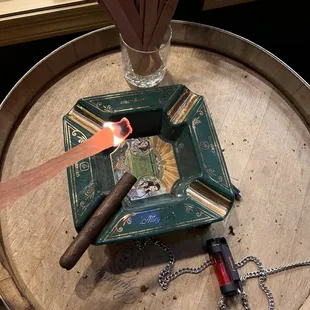 a cigar and cigar lighter