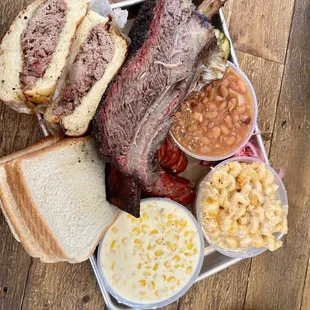 Pulled pork sandwich, Dino rib, jalapeño cheese sausage, beans, Mac and cheese and corn.