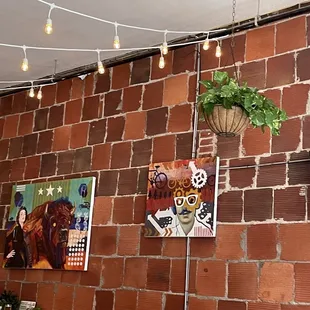 a brick wall with hanging plants