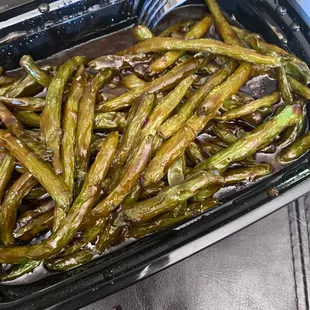a tray of cooked green beans