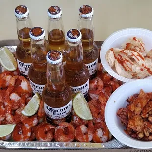 a tray of shrimp, shrimp, and beer