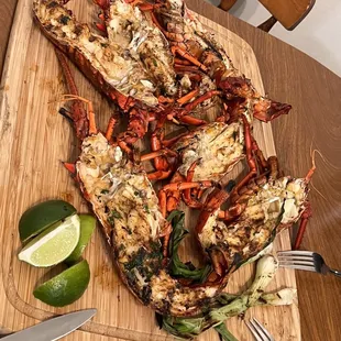 grilled lobsters on a cutting board