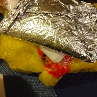 a sandwich wrapped in aluminum foil