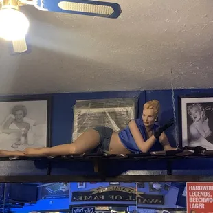 a woman laying on a shelf