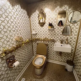 a bathroom with a toilet, sink and mirror