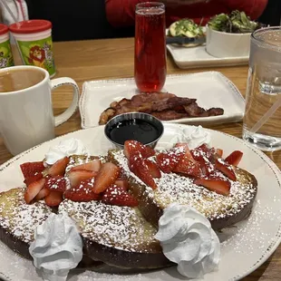  shows a plate of french toast topped with strawberries and whipped cream