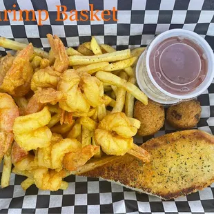 a basket of fried shrimp and fries