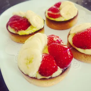 a white plate with four pastries on it