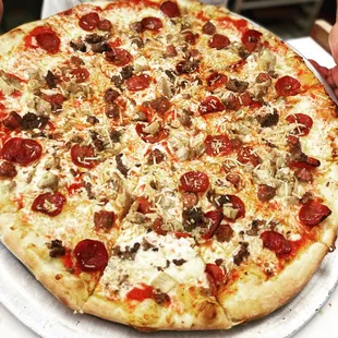 a pizza with pepperoni, mushrooms, and cheese