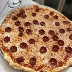 a pepperoni pizza on a pan
