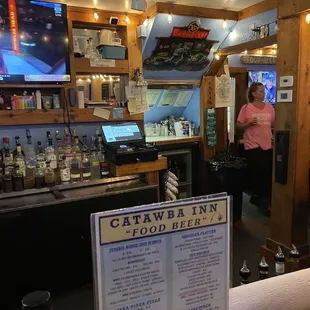 a woman standing at the bar