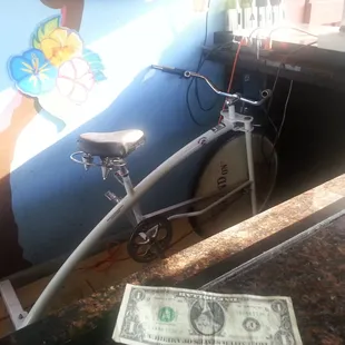 Exercise bike behind bar....get it gurl!