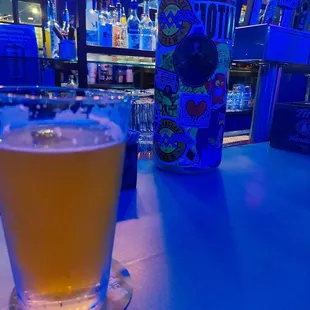 a glass of beer on a bar counter