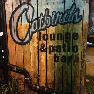 a wooden sign for a bar