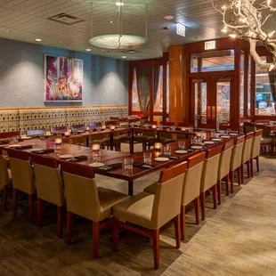 a restaurant with a long table and chairs