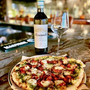 ows a bottle of wine and a pizza