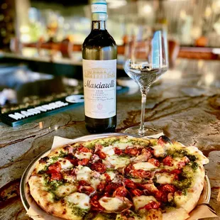 ows a bottle of wine and a pizza