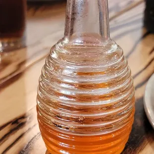 ows a glass bottle of honey