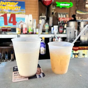 a drink and a beverage in a plastic cup
