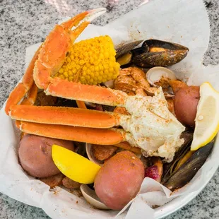 crab legs, potatoes, potatoes, and corn