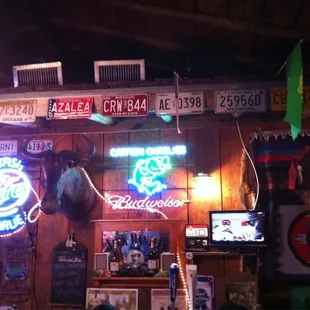a bar with various neon signs