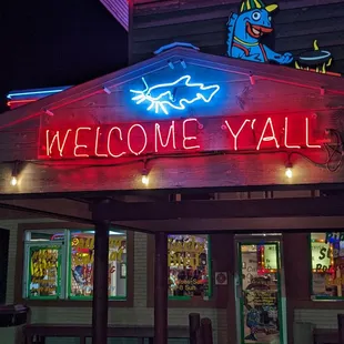 a neon welcome yall sign
