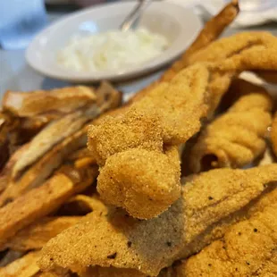 a plate of fried fish and fries