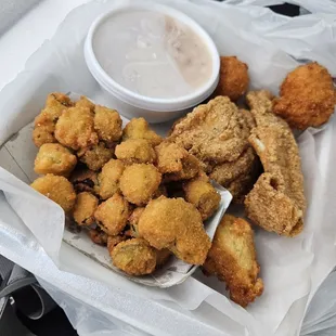 Fried catfish with fried okra, hush puppies, and white beans. It came with one side (we picked fried okra)