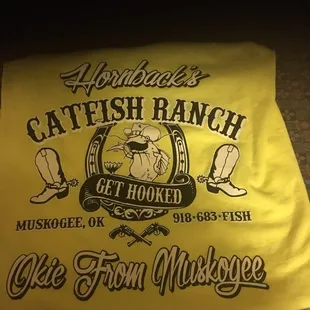 a yellow t - shirt with a picture of a fish on it