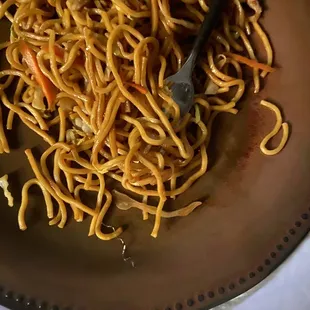 a plate of noodles and carrots